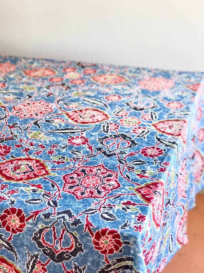blue linen tablecloth with navy, burgandy and red floral pattern on table