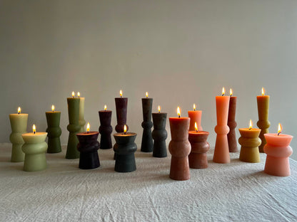 assorted totem candles with flames lit