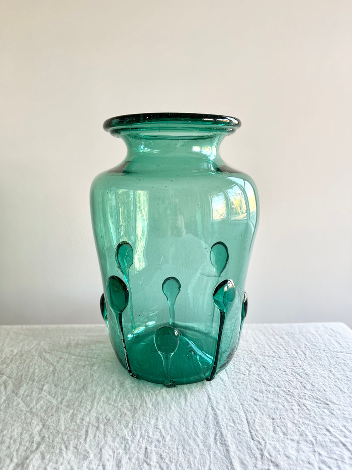 green glass vase with green glass petals on the outside 15 inches tall