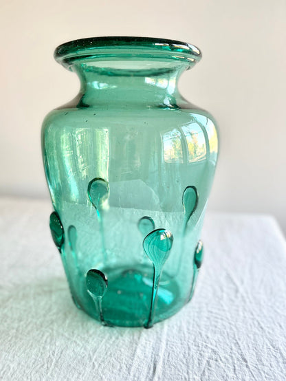 green glass vase with green glass petals on the outside 15 inches tall close up view